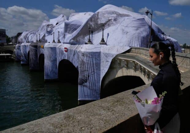 The ‘French Banksy’ creates a ‘cave’ installation over Paris’ oldest bridge