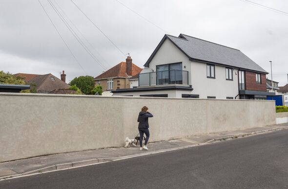 Neighbours in posh seaside spot rage as man erects 75ft-long ‘Berlin Wall’ boundary