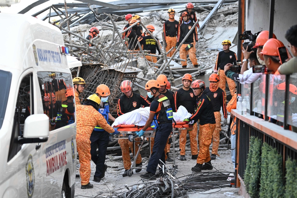 Malaysian among dead after building collapse traps dozens in the Philippines