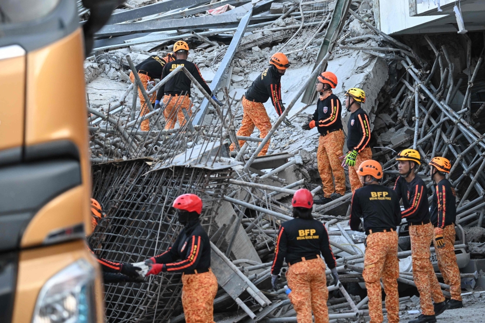 Death toll climbs to three, including Malaysian, and 17 missing after construction site collapse in the Philippines