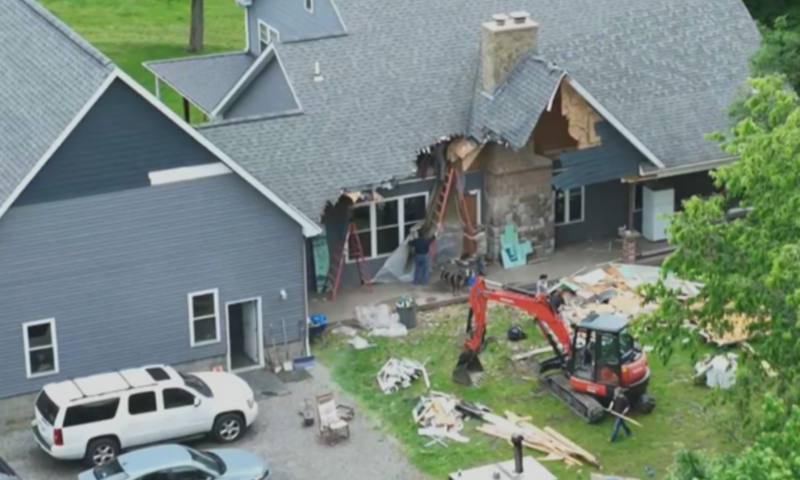 A man used an excavator to tear down the family home – while his wife and their children were still inside, police say