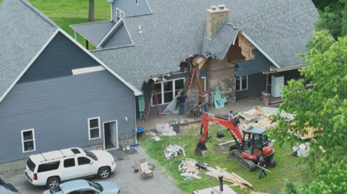 A man used an excavator to tear down the family home – while his wife and their children were still inside, police say