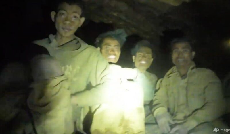 Rescuers evacuate the first of 5 villagers found trapped in a cave in Laos; 2 still missing