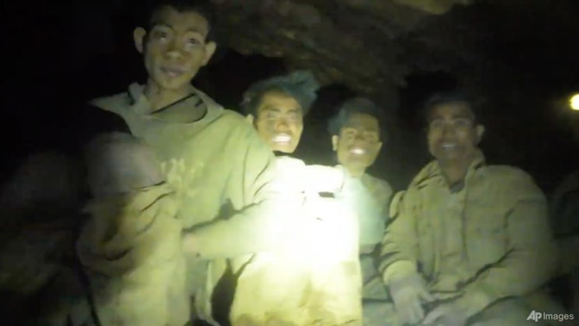 Rescuers evacuate the first of 5 villagers found trapped in a cave in Laos; 2 still missing