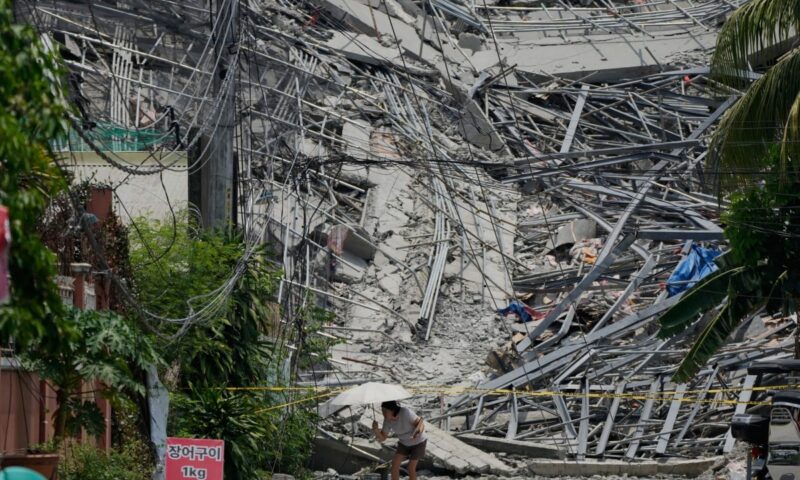 Philippine rescuers race to free workers trapped after hotel collapse
