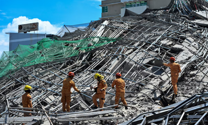 Rescuers search for more than 20 trapped after Philippines building collapse