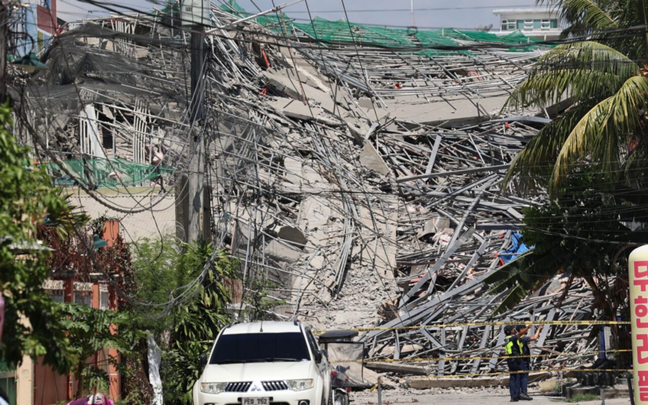 Rescuers search for people trapped under rubble after building collapses in Philippines