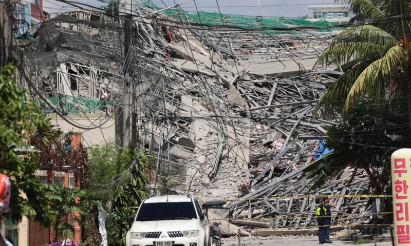 Rescuers search for people trapped under rubble after building collapses in Philippines