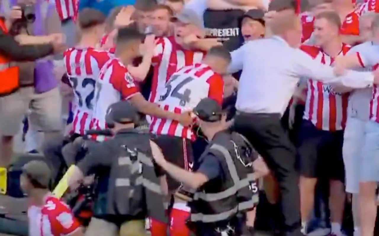 Chaos as Premier League stadium’s advertising board COLLAPSES and security forced to move fans back in stands
