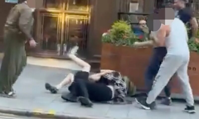 Moment women kick, punch and yank each other’s hair before collapsing to floor in daylight brawl outside Spoons
