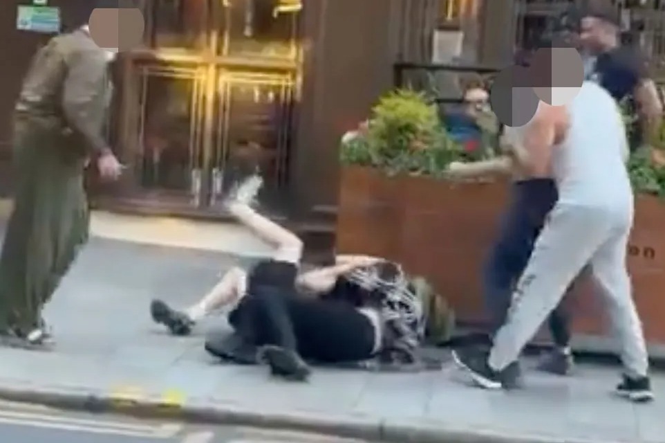 Moment women kick, punch and yank each other’s hair before collapsing to floor in daylight brawl outside Spoons