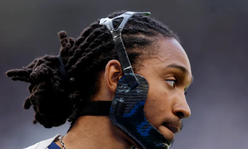 Why is Djed Spence wearing a protective mask for Tottenham against Everton?