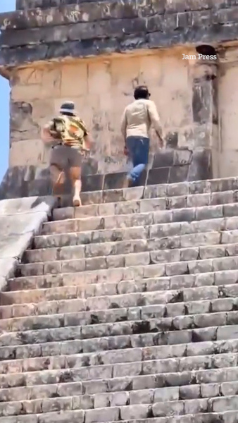 Moment tourists brazenly scale ancient pyramid