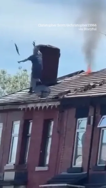 Man launches tiles at police in standoff over roof fire