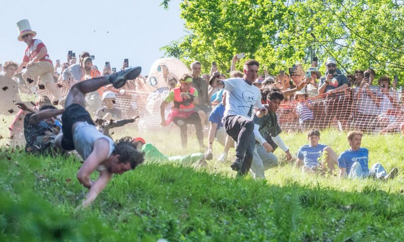 Dozens tumble & SOMERSAULT down hill to chase 8lb wheel of cheese in death-defying annual race watched by thousands