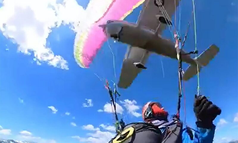 Terrifying moment plane CRASHES into paraglider sending woman spiralling mid-air – before she miraculously lands
