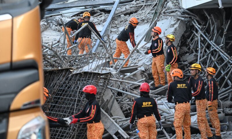 At least one dead and over 20 trapped in rubble after building collapses in Philippines – as major rescue op underway