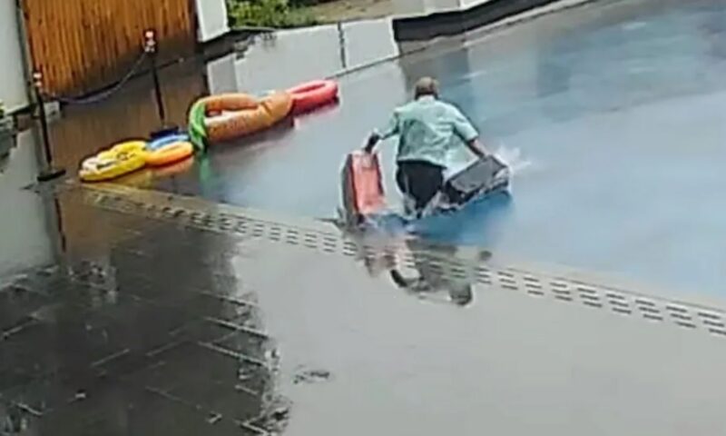 Moment hapless hotel porter walks straight into pool thinking it’s a rainy car park leaving guests’ luggage drenched