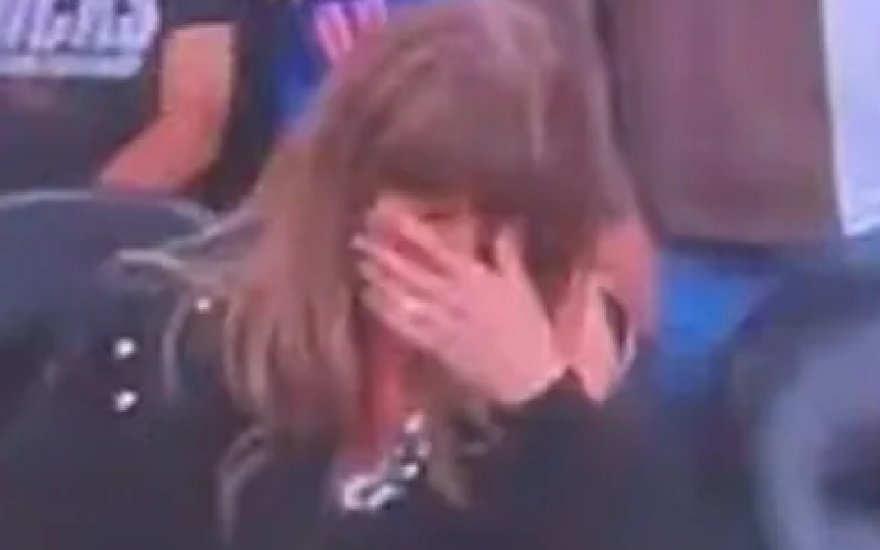 Taylor Swift covers eyes as fiance Travis Kelce downs beer on big screen at NBA game before falling asleep