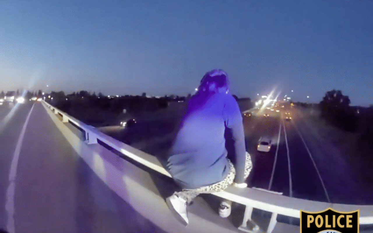 Heart-stopping moment cops rescue sobbing kid dangling dangerously from freeway overpass