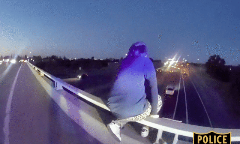 Heart-stopping moment cops rescue sobbing kid dangling dangerously from freeway overpass