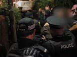 Moment police drag paedophile from his home to protect him from baying mob outside