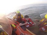 Moment terrified beachgoer is saved from drowning after getting trapped in sinking sands and rising tides