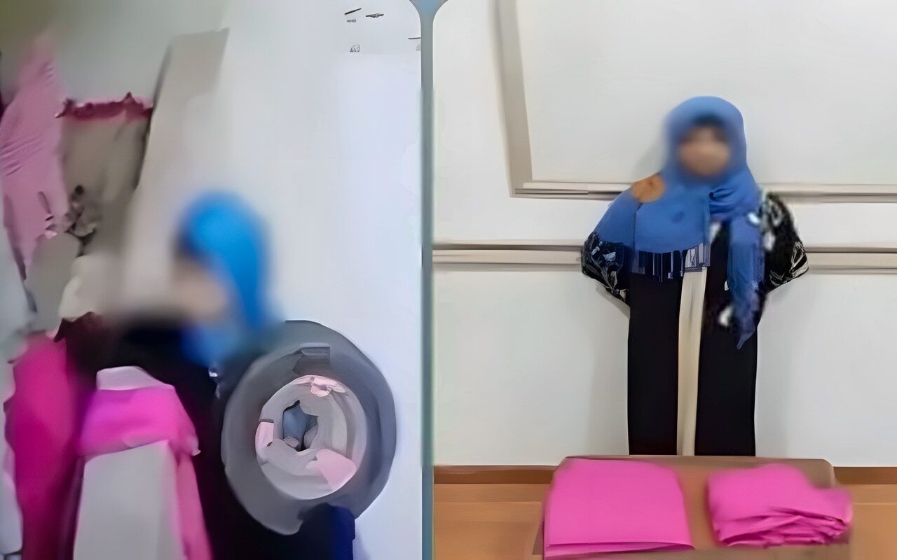 انتهت بالكلابشات، سيدة تسرق ملابس من شرفة شقة سكنية في المحلة